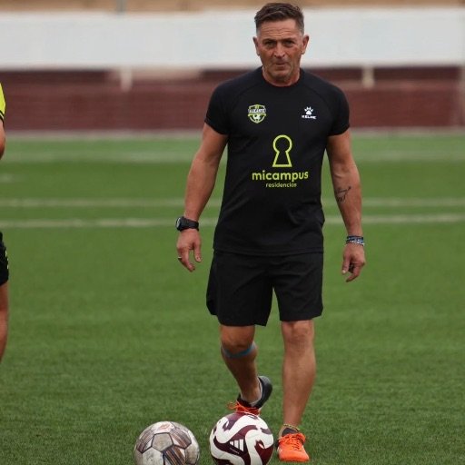 a football coach leading a training session with the ball for how to become a football scout