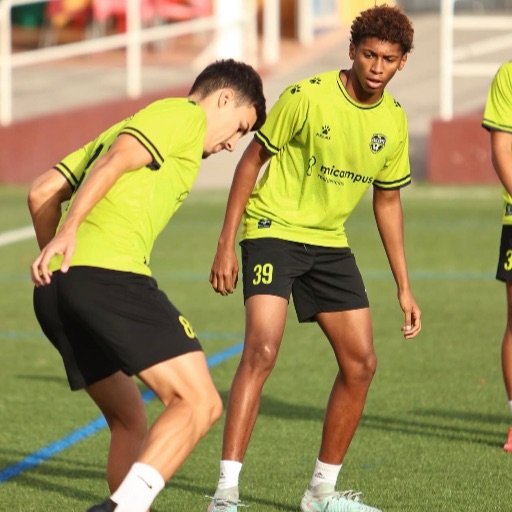 a young football player preparing for training with a ball for how do football scouts contact you