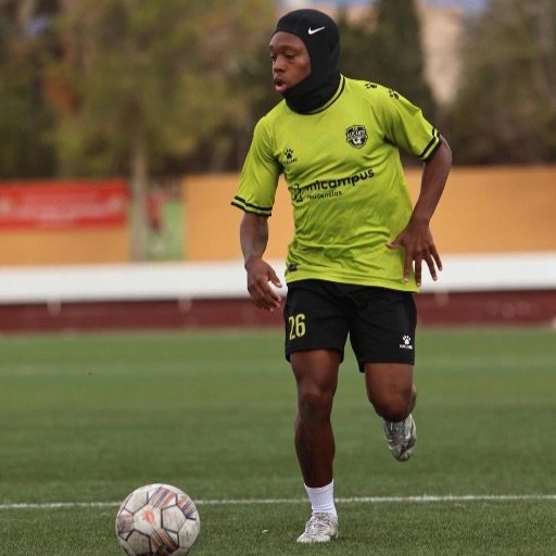 a young football player sprinting with the ball during training for how to become a footballer at 13