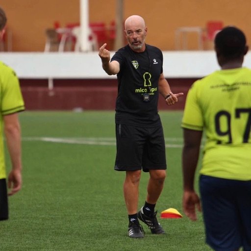 a youth football coach giving instructions during training for what do football scouts look for in 7 year olds