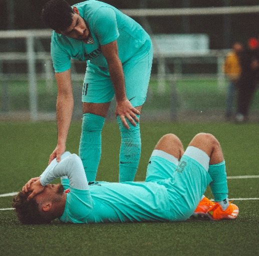 Football player holding head after on field collision