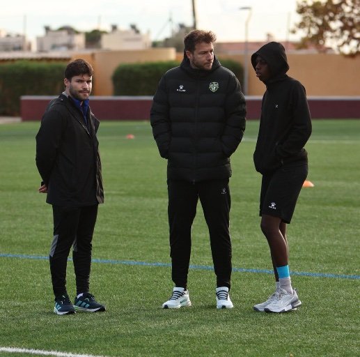 coach analyzing soccer with player