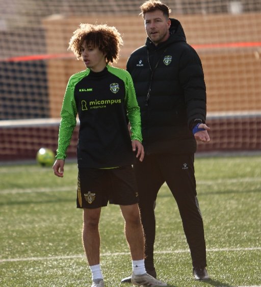 alicante football academy coach giving set piece instructions soccer training