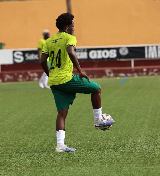alicante football academy player controlling soccer ball on pitch