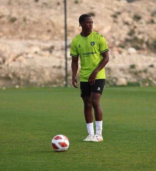 alicante football academy player stands over the ball and scans the field before a pass