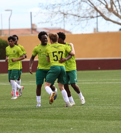 alicante football academy soccer players celebating on the pitch