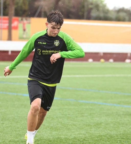 alicante football academy player dribbling ball during training