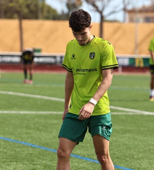 alicante football academy player walking on football pitch
