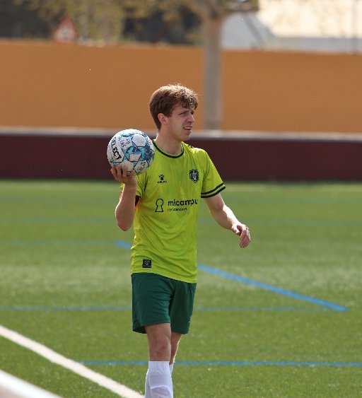 football academy player preparing for throw in