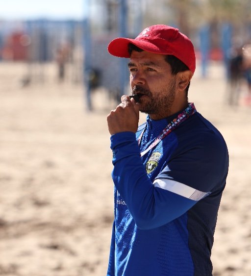 football coach leading beach training session at alicante football academy
