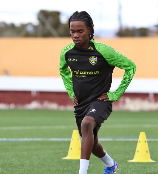 football dynamic warm up player doing walking lunge between cones