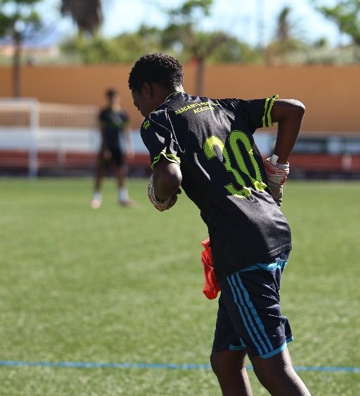 alicante football academy player running during training
