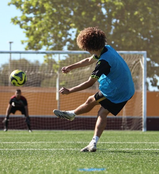 soccer academy player shooting at goal during training