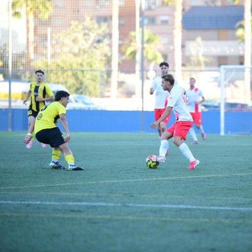 football academy trial player dribbling against a defender
