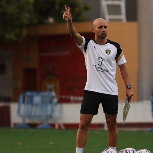 football academy coach giving instructions during training
