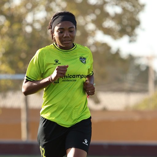 female football player training at girls soccer camp in spain